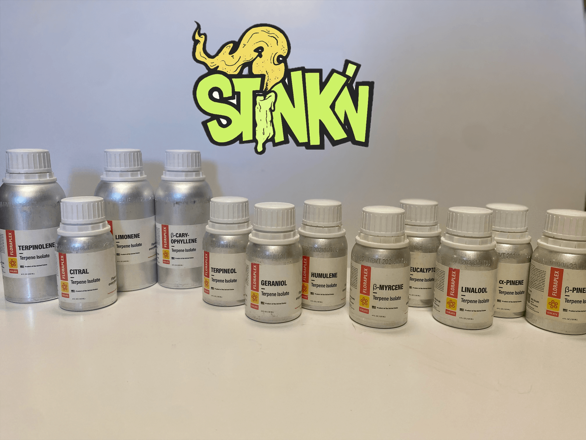 The Stink'n Terpene Isolate lineup — thirteen single-terpene bottles beneath the Stink'n dragon logo